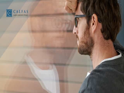 Man Looking Despondently Out of Window