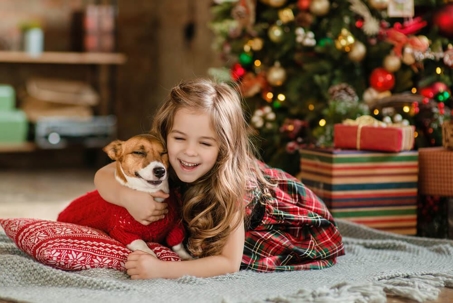 Happy girl and dog at Christmas.