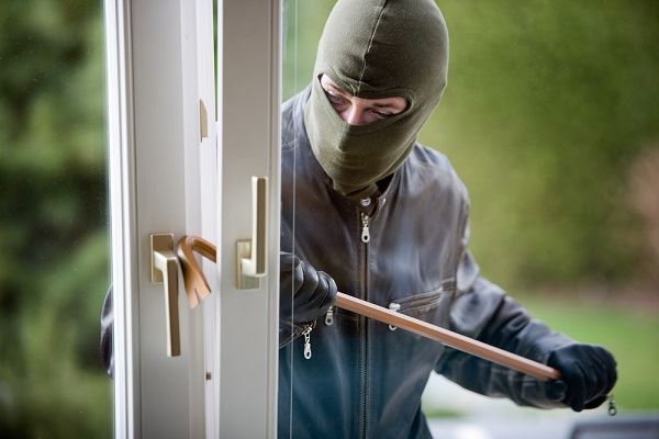 man burglarizing house